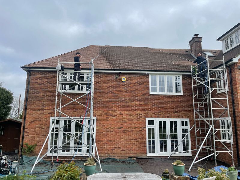 Roof cleaning carried out safely from scaffold towers by The Roof Moss Cleaners in Bulford